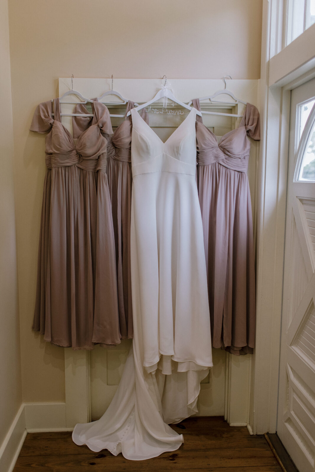 bridesmaids dresses on either side of bridal gown
