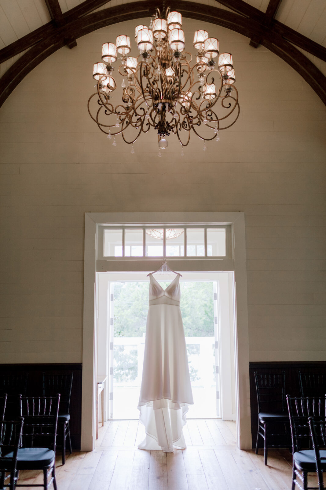 bridal gown hanging from door windows